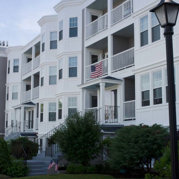 3 story condo building with balconies and bay windows on each level